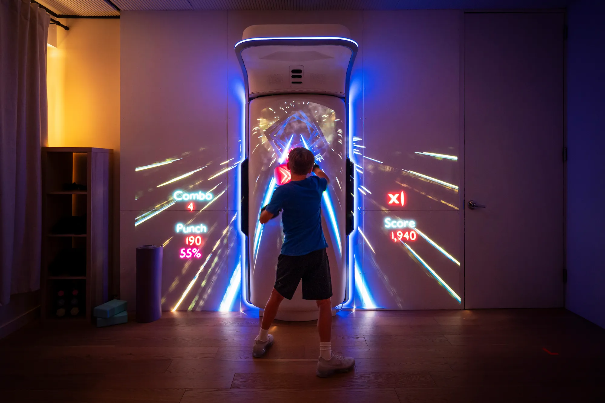 A young boy boxing the Growl boxing bag, gaming mode